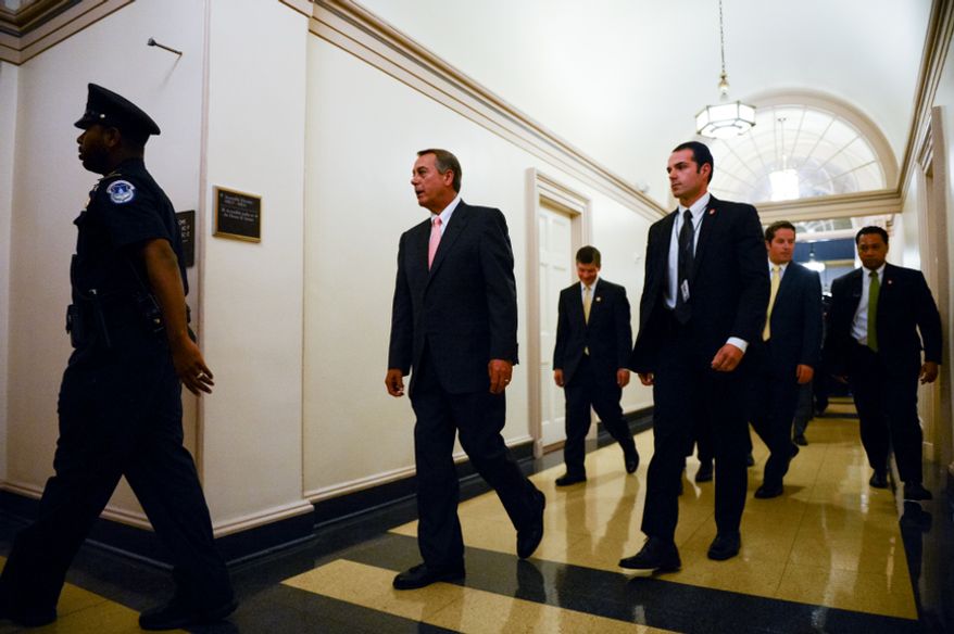 House Speaker John Boehner, (R-Ohio), center, leaves after speaking at a press conference with House Republicans at the U.S. Capitol Building, Washington, D.C., Thursday, October 10, 2013. (Andrew Harnik/The Washington Times)