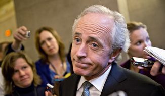 ** FILE ** Sen. Bob Corker, R-Tenn., shrugs as he talks to reporters about a two-hour meeting at the White House that he and other Senate Republicans had with President Barack Obama, trying to come up with a bipartisan solution to the budget stalemate, Friday, Oct. 11, 2013, on Capitol Hill in Washington. (AP Photo/J. Scott Applewhite)