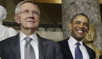 President Obama and Senate Majority Leader Harry Reid of Nevada smile for photographers on Capitol Hill in Washington after the unveiling of a statue of Rosa Parks in February 2013. (Associated Press) **FILE**