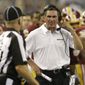 Washington Redskins head coach Mike Shanahan, right, shouts in the first half of an NFL football game against the Dallas Cowboys, Sunday, Oct. 13, 2013, in Arlington, Texas. (AP Photo/LM Otero) 
