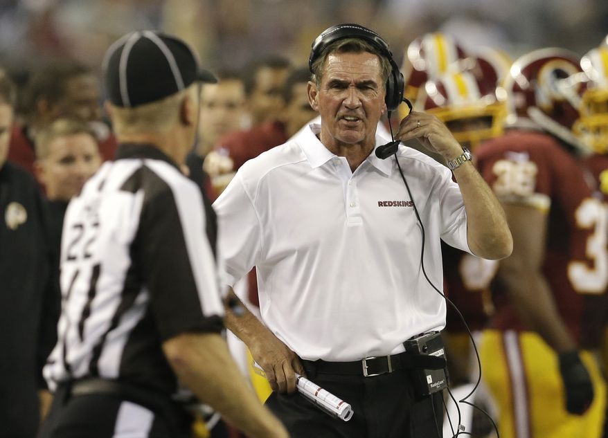 Washington Redskins head coach Mike Shanahan, right, shouts in the first half of an NFL football game against the Dallas Cowboys, Sunday, Oct. 13, 2013, in Arlington, Texas. (AP Photo/LM Otero)