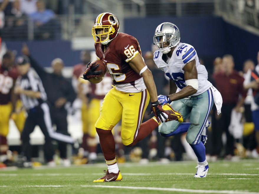Washington Redskins tight end Jordan Reed (86) carries the ball as Dallas Cowboys free safety Barry Church (42) defends in the first half of an NFL football game, Sunday, Oct. 13, 2013, in Arlington, Texas. (AP Photo/Tim Sharp)