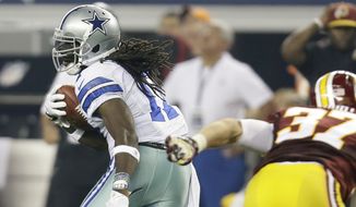 Dallas Cowboys wide receiver Dwayne Harris (17) escapes a tackle attempt by Washington Redskins&#39; Reed Doughty (37) on a punt return in the second half of an NFL football game, Sunday, Oct. 13, 2013, in Arlington, Texas. (AP Photo/Tim Sharp) 