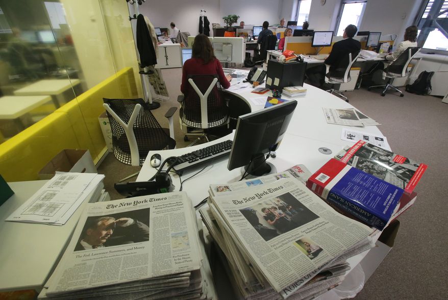 In this Oct. 4, 2013 photo shows a view of the newsroom of the International Herald Tribune, who will be rebranded as the International New York Times on Tuesday, Oct. 15, 2013 at the International Herald Tribune headquarters in Paris. The International Herald Tribune, a celebrated newspaper that long gave U.S. expatriates a cherished lifeline to events back home and a dose of Americana for foreign readers, published its last edition on Monday Oct. 14, 2013. It was 126 years old. (AP Photo/Michel Euler)