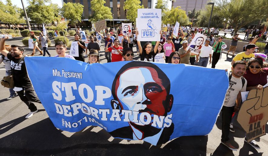 Upset with President Barack Obama&#39;s immigration policy, about 250 people march to the U.S. Immigrations and Customs Enforcement office with a goal of stopping future deportations on Monday Oct. 14, 2013, in Phoenix.  The protesters chanted &quot;no more deportations&quot; and &quot;shut down ICE.&quot; (AP Photo/Ross D. Franklin)