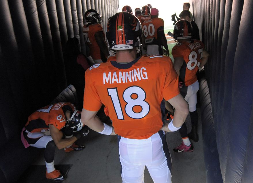 Denver Broncos quarterback Peyton Manning waits for introductions during an NFL football game against the Jacksonville Jaguars, Sunday, Oct. 13, 2013, in Denver. (AP Photo/Jack Dempsey)