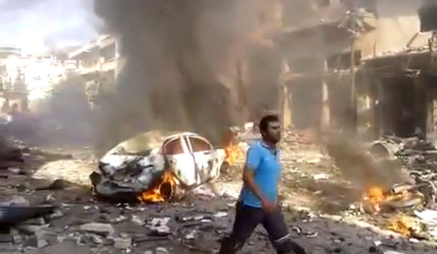 This image made from citizen journalist video posted by the Shaam News Network, which is consistent with other AP reporting, shows the aftermath of a car bomb attack on a market in the town of Darkoush in Idlib province, Monday, Oct. 14, 2013. (AP Photo/Shaam News Network via AP video)