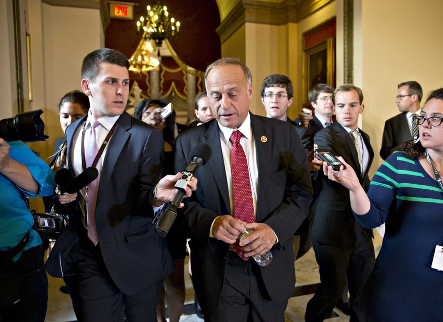 Rep. Steve King, R-Iowa, walks from House Speaker John Boehner’s office with reporters in pursuit, at the Capitol in Washington, Tuesday, Oct. 15, 2013. Time growing desperately short, House Republicans pushed for passage of legislation late Tuesday to prevent a threatened Treasury default, end a 15-day partial government shutdown and extricate divided government from its latest brush with a full political meltdown. (AP Photo/J. Scott Applewhite)