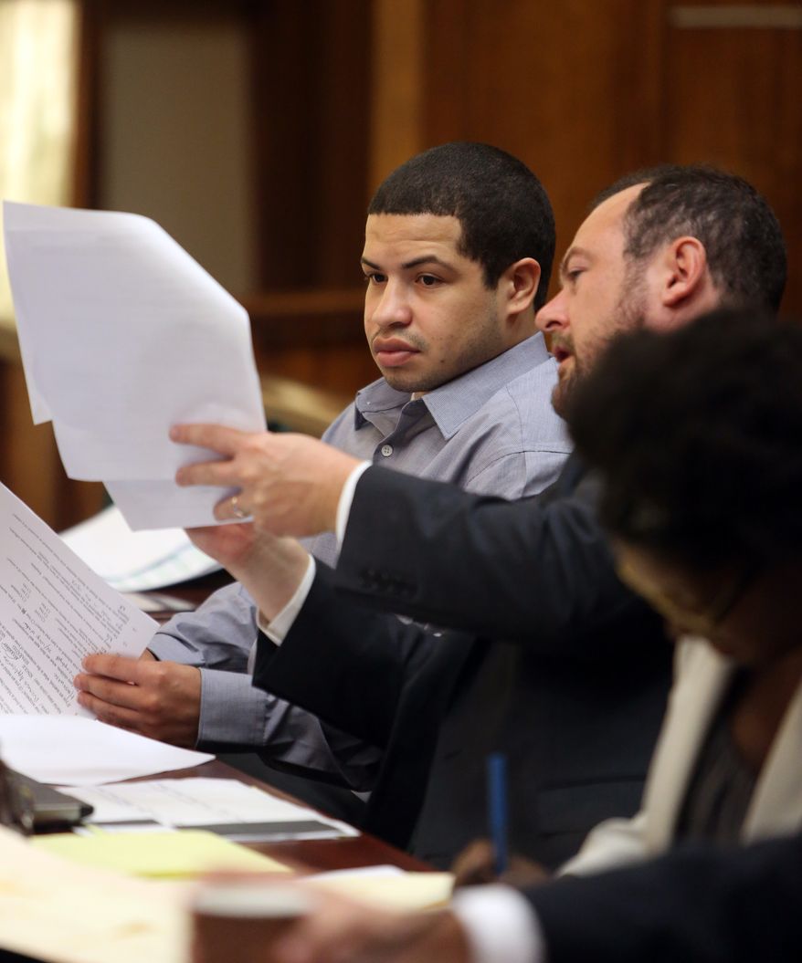 Eric Rivera Jr., left, talks with attorney Christopher Brown during jury selection Monday, Oct.15, 2013, in Miami. Rivera is accused in the 2007 slaying of Washington Redskins star safety Sean Taylor during what police say was a botched burglary attempt. (AP Photo/The Miami Herald, Walter Michot, pool)
