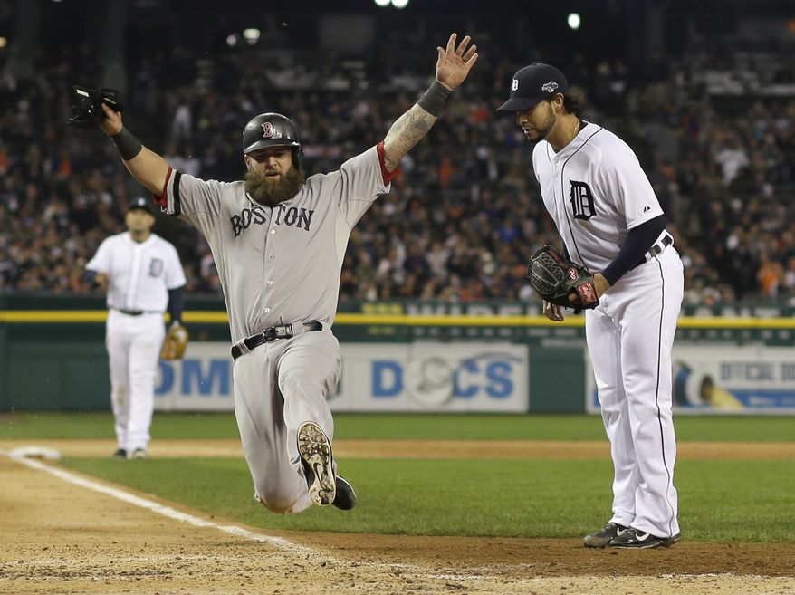 Boston Red Sox's Mike Napoli scores on a wild pitch by Detroit Tigers' Anibal Sanchez, right, in the third inning during Game 5 of the American League baseball championship series Thursday, Oct. 17, 2013, in Detroit. (AP Photo/Matt Slocum)