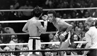 FILE - In this Nov. 25, 1980 file photo, Sugar Ray Leonard, right, taunts at Roberto Duran in the ring during a WBC Welterweight Championship fight refereed by Octavio Meyran in New Orleans, La. Leonard won the rematch fight and the title in the eighth round.  (AP Photo, File)