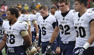 Navy kicker Nick Sloan (6) and his teammate walk off the field after a 45-44 double-overtime loss to Toledo in an NCAA college football game in Toledo, Ohio, Saturday, Oct. 19, 2013. Sloan missed an extra point in double overtime. (AP Photo/David Richard)