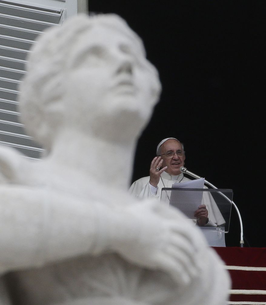 Pope Francis delivers his message from his studio window overlooking the crowd gathered in St. Peter's Square during his Angelus prayer, at the Vatican, Sunday, Oct. 20, 2013. During the Angelus the pontiff expressed his closeness to the Philippines for the recent 7.2 magnitude earthquake which left at least 171 people dead. (AP Photo/Gregorio Borgia)