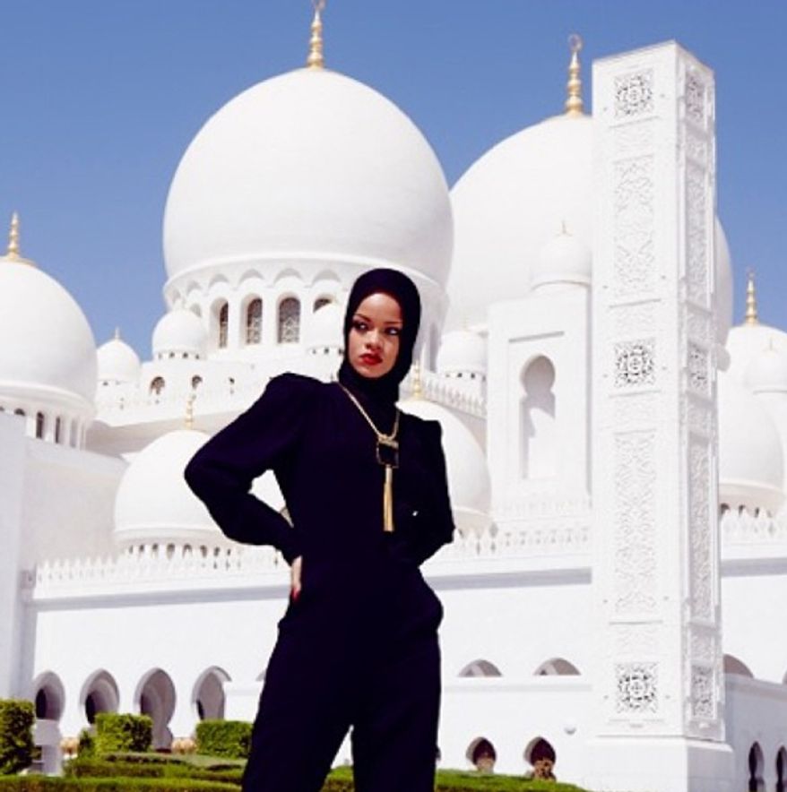 In this photo posted to an Instagram account belonging to Rihanna, pop star Rihanna poses for a photo in front of Abu Dhabi's Grand Mosque in the United Arab Emirates. Overseers of Abu Dhabi's Grand Mosque say they asked Rihanna to leave the compound after she posed for photographs considered to be at odds with the "sanctity" of the site. Rihanna, who was in the city for a concert on Saturday, Oct. 19, 2013, hasn't publicly responded to the actions by staff at the Sheikh Zayed Grand Mosque. (AP Photo/via Instagram)