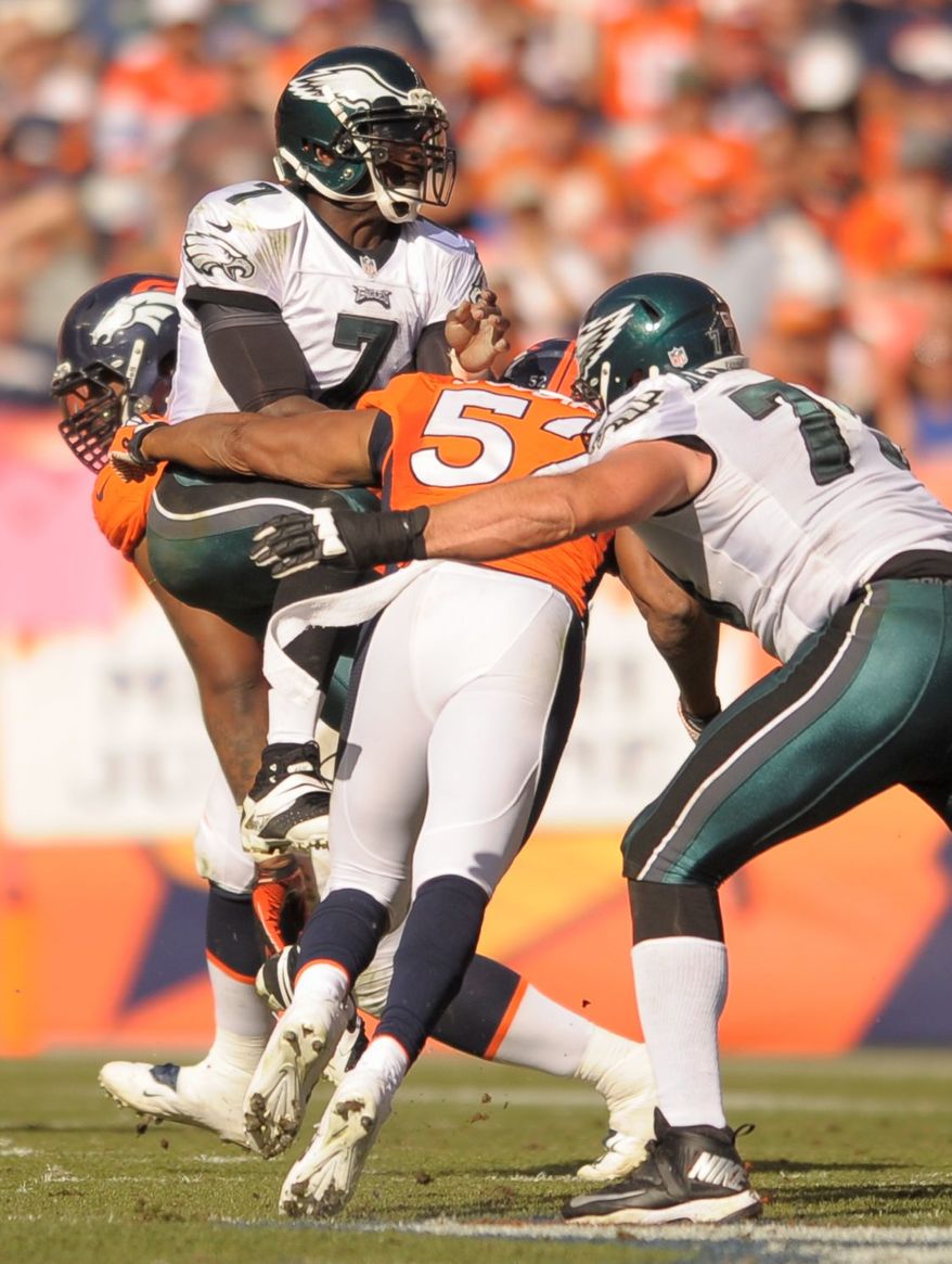 Eagles quarterback Michael Vick has missed the past two games with a hamstring injury. His replacement, Nick Foles, is out this week with a concussion. (associated press)