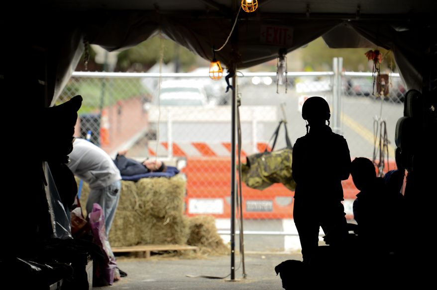 Riders and grounds crew work in the outdoor horse stables set up on F Street as the Washington International Horse Show holds its 55th annual championship at the Verizon Center in Chinatown, Washington, D.C., Tuesday, October 22, 2013. The show will run through this weekend and feature a variety of competitions with riders of all ages. (Andrew Harnik/The Washington Times)