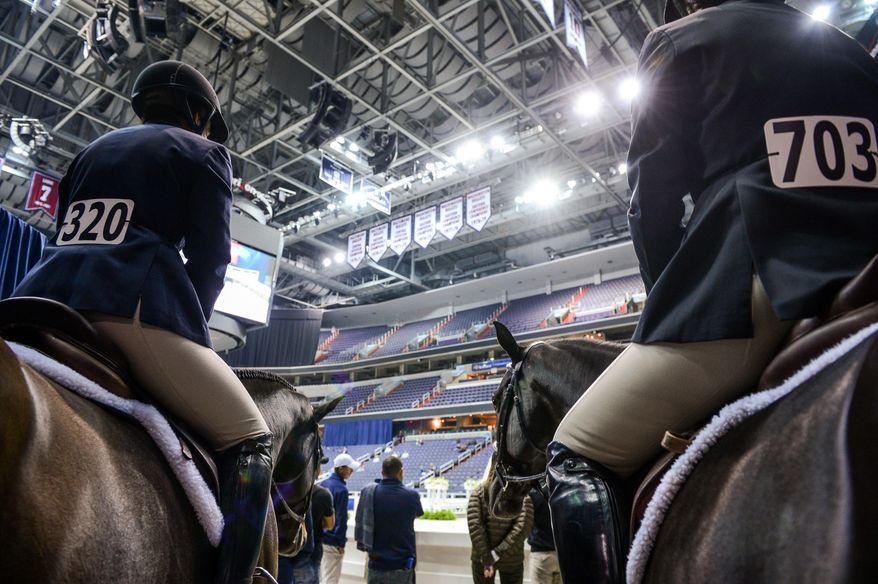 Riders wait to compete in the 35+ amateur riders competition as the Washington International Horse Show holds its 55th annual championship at the Verizon Center in Chinatown, Washington, D.C., Tuesday, October 22, 2013. The show will run through this weekend and feature a variety of competitions with riders of all ages. (Andrew Harnik/The Washington Times)