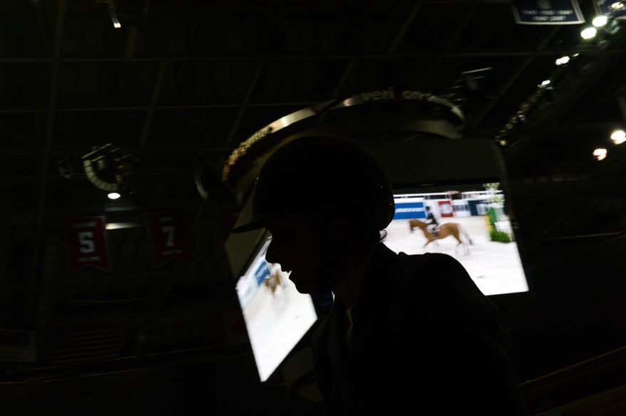 A rider waits to compete in the 35+ amateur riders competition as the Washington International Horse Show holds its 55th annual championship at the Verizon Center in Chinatown, Washington, D.C., Tuesday, October 22, 2013. The show will run through this weekend and feature a variety of competitions with riders of all ages. (Andrew Harnik/The Washington Times)
