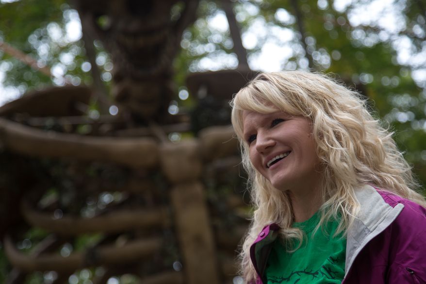 Jill Bennett, owner of the Creepy Woods Haunted Woods and Bennett's Curse Haunted Houses, stands under a 35 foot tall animatronic skeleton that they just installed this year, in Kingsville, MD., Wednesday, October 16, 2013. (Andrew S Geraci/The Washington Times)