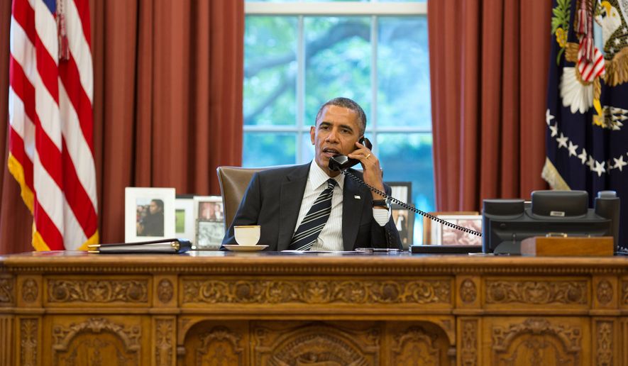 President Barack Obama talks on the phone in the Oval Office, Sept. 27, 2013. (Official White House Photo by Pete Souza) 