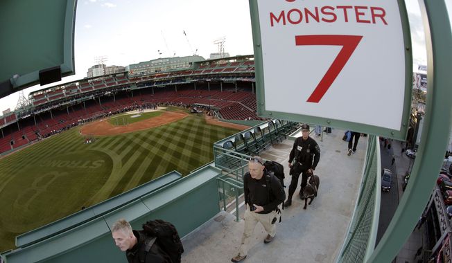 Security personnel make their way around Fenway Park before Game 2 of baseball&#x27;s World Series between the Boston Red Sox and the St. Louis Cardinals Thursday, Oct. 24, 2013, in Boston. (AP Photo/Charlie Riedel) 