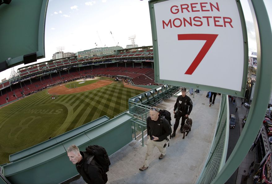 Security personnel make their way around Fenway Park before Game 2 of baseball's World Series between the Boston Red Sox and the St. Louis Cardinals Thursday, Oct. 24, 2013, in Boston. (AP Photo/Charlie Riedel)