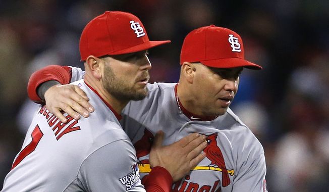 St. Louis Cardinals&#x27; Matt Holliday, left, and Carlos Beltran celebrate after Game 2 of baseball&#x27;s World Series against the Boston Red Sox Thursday, Oct. 24, 2013, in Boston. The Cardinals won 4-2 to tie the series at 1-1. (AP Photo/Elise Amendola) 
