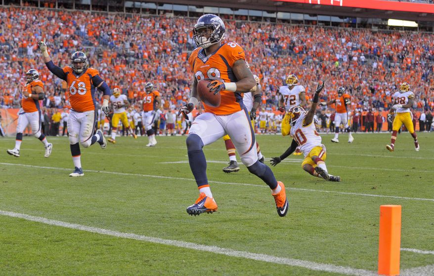 Denver Broncos wide receiver Demaryius Thomas (88) crosses the goal line for a touchdown against the Washington Redskins in the fourth quarter of an NFL football game, Sunday, Oct. 27, 2013, in Denver. (AP Photo/Jack Dempsey)