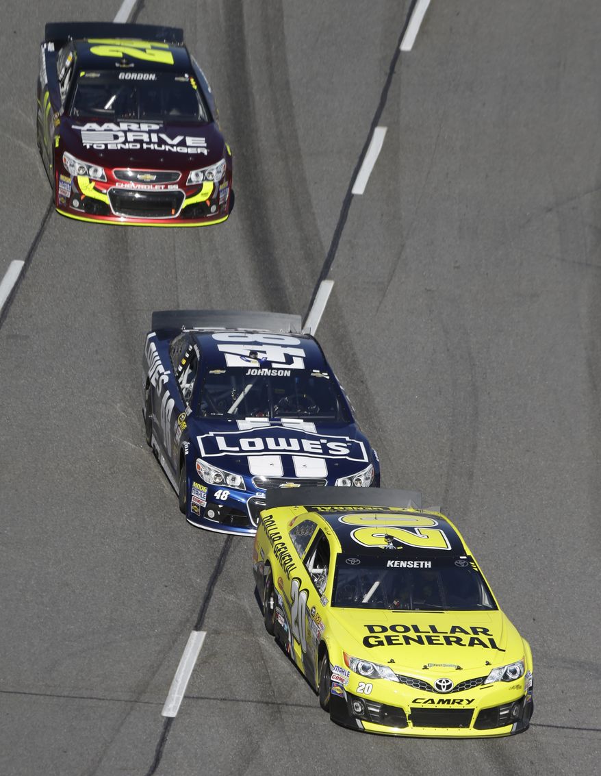 Sprint Cup Series driver Matt Kenseth (20) is followed by Jimmie Johnson (48) and Jeff Gordon (24) during the early going of the NASCAR Sprint Cup auto race at Martinsville Speedway in Martinsville, VA., Sunday, Oct. 27, 2013. (AP Photo/Steve Helber)