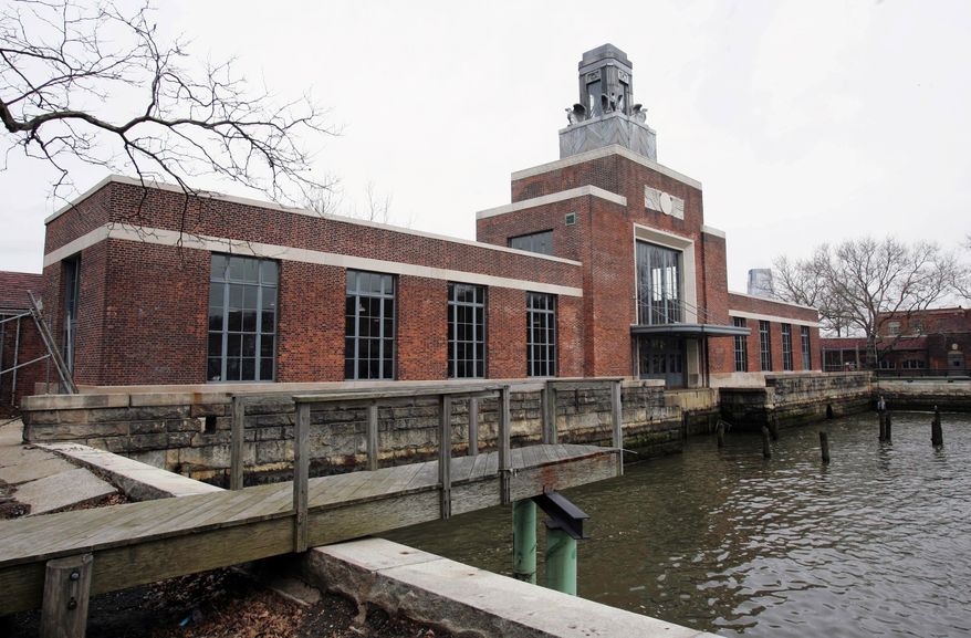 ** FILE ** This March 26, 2007, file photo shows the ferry building on Ellis Island, N.J. The National Parks Service says the Ellis Island Immigration Museum will reopen to the public on Monday, Oct. 28, 2013. It's been about a year since Superstorm Sandy brought water levels as high as 8 feet to the iconic former U.S. immigration entry point. (AP Photo/Mike Derer, File)