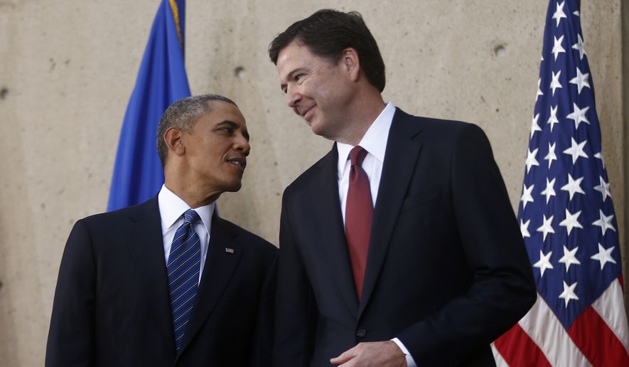President Barack Obama talks with FBI Director James Comey during Comey's installation as FBI director, Monday, Oct. 28,2013, at FBI Headquarters in Washington. The president said he picked Comey to lead the FBI after interviewing many other candidates for the job. The president said at an installation ceremony for the new FBI director Monday afternoon that it wasn't Comey's educational or professional background that made him the the choice. He said it was a sense that Comey knows what's right and what's wrong.  (AP Photo/Charles Dharapak)