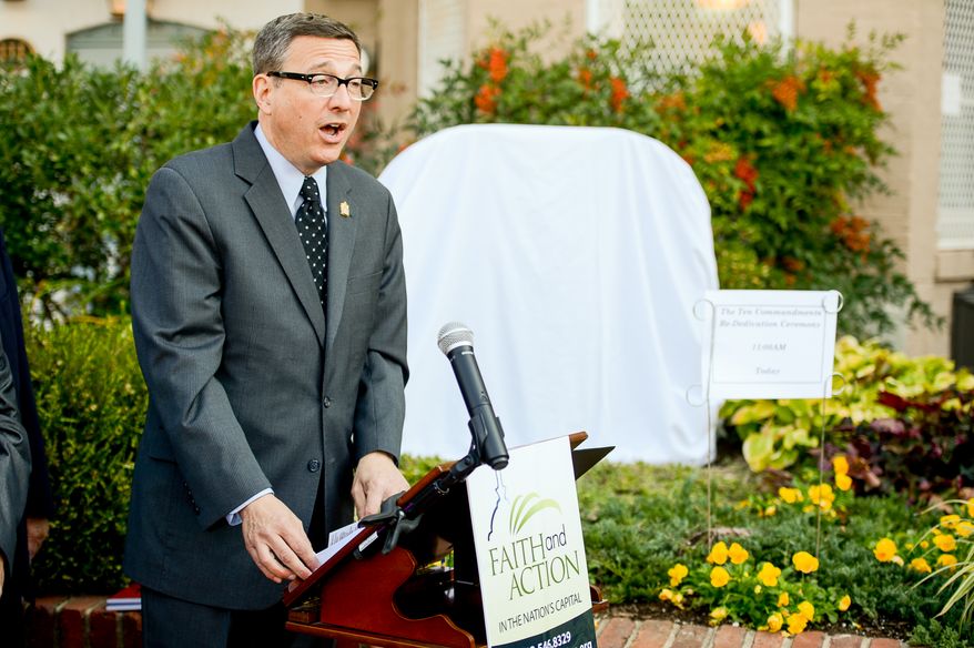 Rev. Rob Schenck, president of Faith and Action speaks before unveiling their depiction of the Ten Commandments again, background, across the street from the Supreme Court after vandals pulled it over, Washington, D.C., Tuesday, October 29, 2013. (Andrew Harnik/The Washington Times)