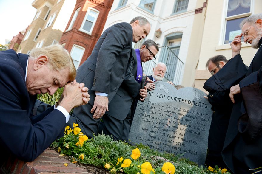 Religious leaders join the president of Faith and Action as he unveils their depiction of the Ten Commandments again after vandals pulled it over, Washington, D.C., Tuesday, October 29, 2013. (Andrew Harnik/The Washington Times)