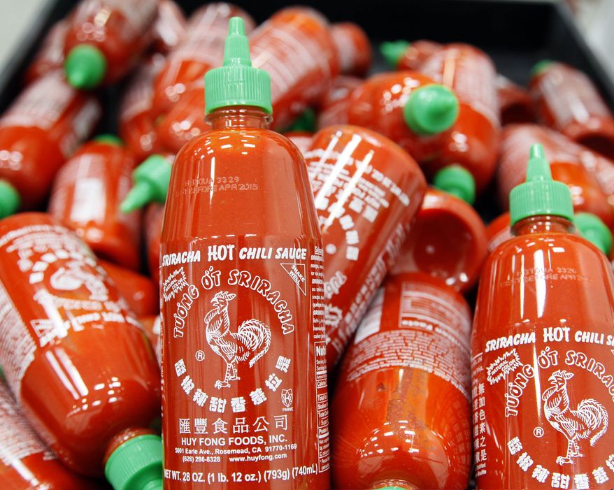 ** FILE ** Sriracha chili sauce bottles are produced at the Huy Fong Foods factory in Irwindale, Calif., in this Tuesday, Oct 29, 2013, file photo. (AP Photo/Nick Ut)