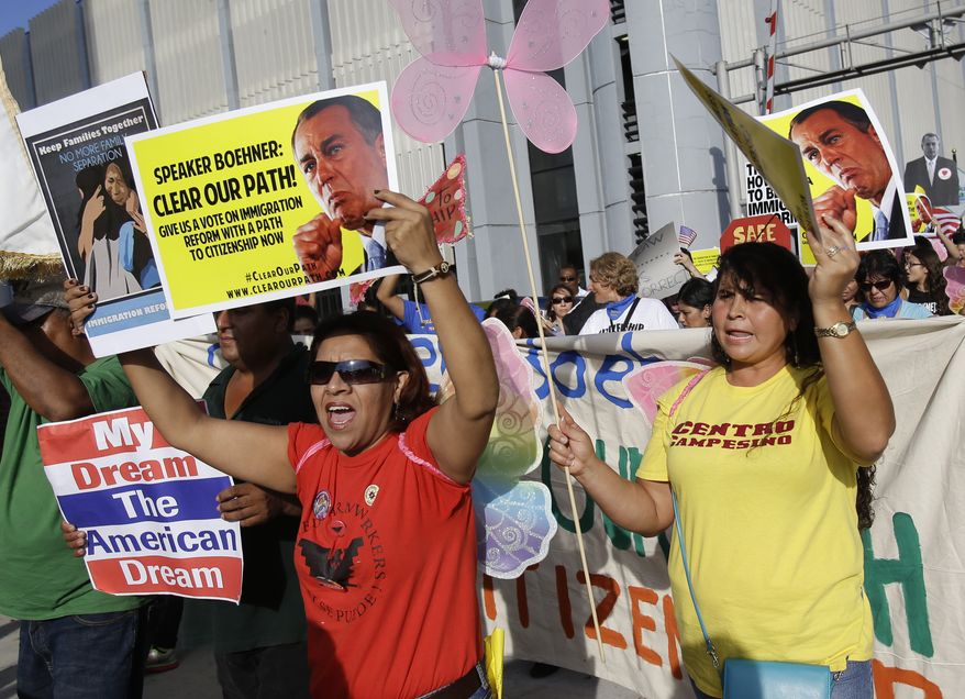Immigration reform advocates march and rally through the downtown streets , Tuesday, Oct. 29, 2013, in Orlando, Fla. The march and rally was to support passage of a pathway-to-citizenship bill for immigration reform. (AP Photo/John Raoux)