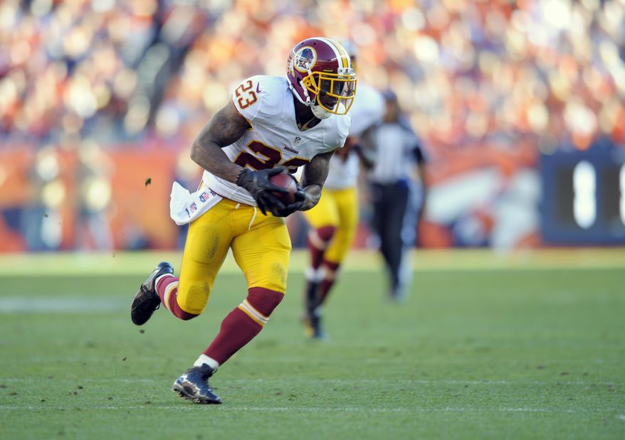 Washington Redskins cornerback DeAngelo Hall runs an interception back for a touchdown against the Denver Broncos during an NFL football game Sunday, Oct. 27, 2013, in Denver. (AP Photo/Jack Dempsey)