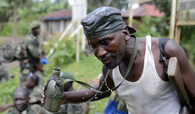 ** FILE ** A Congolese army soldier cools down in Jomba, Congo, during the army&#x27;s advance toward Bunagana through rebel-held territory. Wednesday, Oct. 30, 2013. The Congolese army retook one of the last remaining strongholds of the M23 rebels Wednesday, with fighters heading for the hills as the military sought to extinguish the 18-month insurrection, officials said. (AP Photo/Joseph Kay)