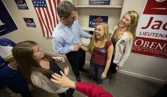 Anna Nunnelly, 17, from Glen Allen, VA., laughs as she shakes hands with Ken Cuccinelli during a campaign stop, in Glen Allen, VA., Wednesday, October 30, 2013.  (Andrew S Geraci/The Washington Times)