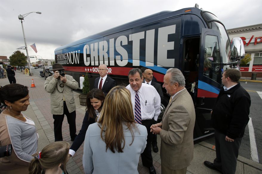 New Jersey Gov. Chris Christie, center facing camera, is greeted by supporters and Linden Mayor Richard J. Gerbounka, center, left, in Linden, N.J., Wednesday, Oct. 30, 2013, as he made a stop on a multi-day bus tour to close out his re-election campaign. Christie faces Democratic challenger Barbara Buono in the Tuesday, Nov. 5, 2013, election. (AP Photo/Mel Evans)