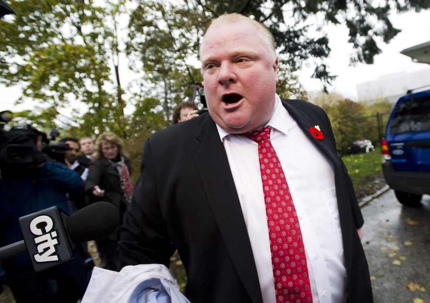 Toronto Mayor Rob Ford tells the media to get off his property as he leaves his home in Toronto on Thursday, Oct. 31, 2013. (AP Photo/Nathan Denette)