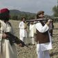 FILE -  In this Sunday, Oct. 4, 2009 file photo, Pakistani Taliban chief Hakimullah Mehsud,  right, holds a rocket launcher with his comrades in Sararogha of Pakistani tribal area of South Waziristan along the Afghanistan border. Intelligence officials said Friday, Nov. 1, 2013 that the leader of the Pakistani Taliban Hakimullah Mehsud was one of three people killed in a U.S. drone strike. (AP Photo/Ishtiaq Mehsud, File)