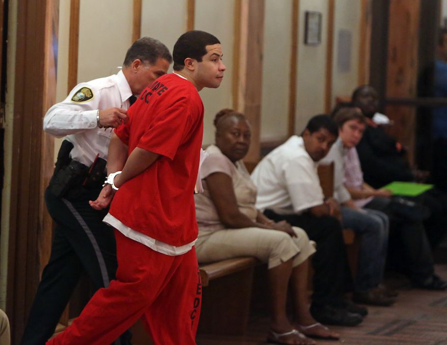 Eric Rivera Jr. is moved through the hallway to the courtroom holding room on Friday, Nov. 1, 2013, during the third day of deliberations in the Sean Taylor murder trial in Miami. Rivera is accused of fatally shooting Washington Redskins star Sean Taylor. (AP Photo/The Miami Herald, Walter Michot) MAGS OUT