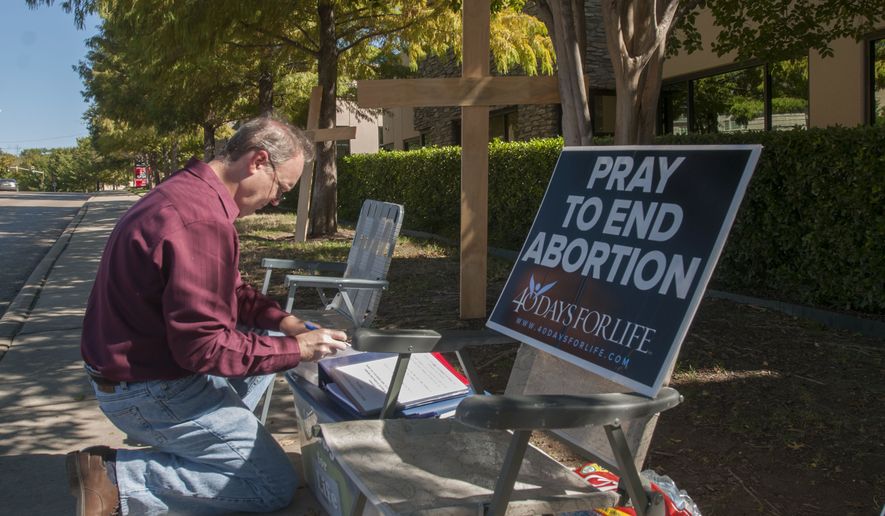 Lee Valerius signs in at a vigil outside an abortion clinic in Dallas, Texas last November following a federal appeals court ruling upholding most of the state&#x27;s new abortion restrictions. (AP Photo/Rex C. Curry)