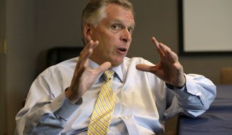** FILE ** This photo taken Tuesday, Oct. 15, 2013, shows Virginia Democratic gubernatorial candidate Terry McAuliffe gesturing during an interview in Richmond, Va. (AP Photo/Steve Helber)