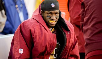 Washington Redskins quarterback Robert Griffin III (10) sits on the sideline in the fourth quarter as the Washington Redskins play the San Diego Chargers at FedExField, Landover, Md., Sunday, November 3, 2013. (Andrew Harnik/The Washington Times)