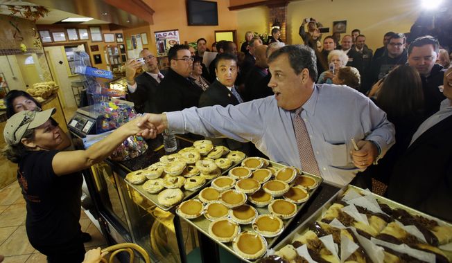 New Jersey Gov. Chris Christie greets workers at Oasis Pastry Shop during a campaign stop in Hillside, N.J., on Monday, Nov. 4, 2013. Mr. Christie will face Democratic gubernatorial candidate Barbara Buono at the polls on Tuesday. (AP Photo/Mel Evans)