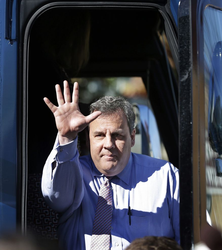 New Jersey Gov. Chris Christie waves to supporters during a campaign stop in Hillside, N.J., Monday, Nov. 4, 2013. Christie will face Democratic candidate, Barbara Buono in an election Tuesday, Nov. 5, 2013. (AP Photo/Mel Evans)
