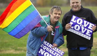 Jerry Bowman, left, and David Strzepek join other supporters of Social Security benefits for same sex couples during a marriage equality rally Monday, Nov. 4, 2013, in Springfield, Ill. Illinois lawmakers return to the Capitol Tuesday for the final week of veto session and are expected to consider gay marriage legislation. (AP Photo/Seth Perlman)