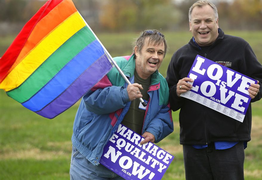 Jerry Bowman, left, and David Strzepek join other supporters of Social Security benefits for same sex couples during a marriage equality rally Monday, Nov. 4, 2013, in Springfield, Ill. Illinois lawmakers return to the Capitol Tuesday for the final week of veto session and are expected to consider gay marriage legislation. (AP Photo/Seth Perlman)