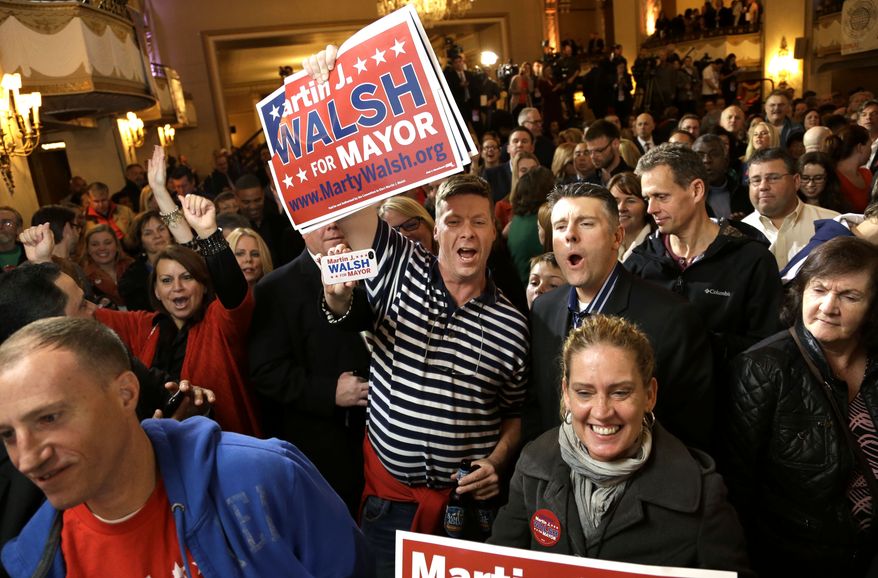 Martin Davis, of Weymouth, Mass., center, a Martin Walsh supporter, holds a placard while reacting to televised returns in the race for mayor of Boston during a watch party at a hotel in Boston, Tuesday, Nov. 5, 2013. Mass. State Rep. Martin Walsh, D-Boston, and City Councilor John Connolly are running for the office held by Boston Mayor Thomas Menino for more than two decades. (AP Photo/Steven Senne)